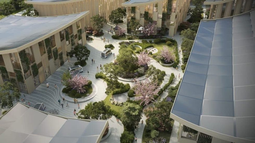 Pedestrians share a Woven City courtyard with Toyota’s e-Palette autonomous vehicles