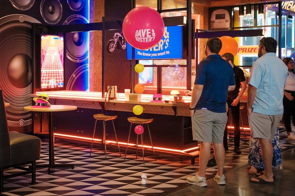 people at Dave & Busters playing Supercharged Shuffle