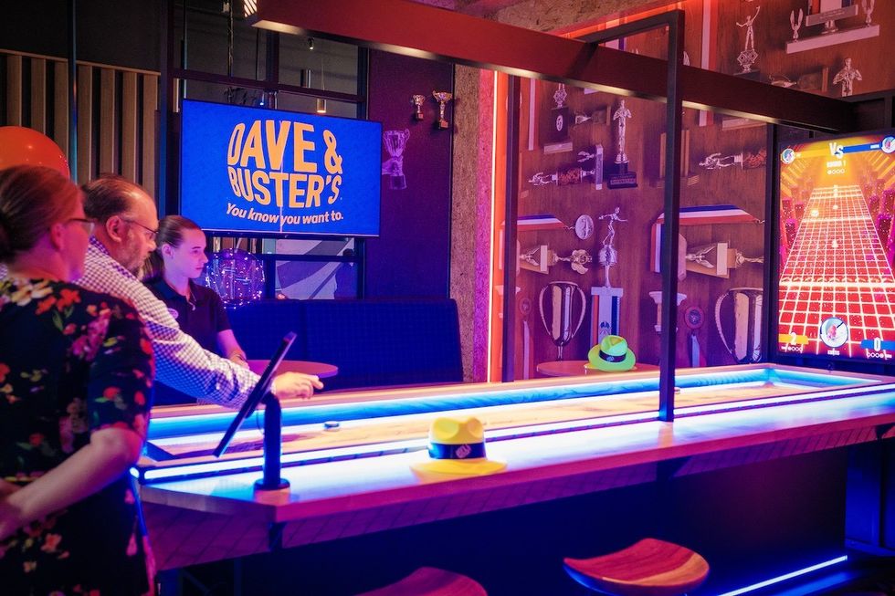 people at Dave & Busters playing Supercharged Shuffle
