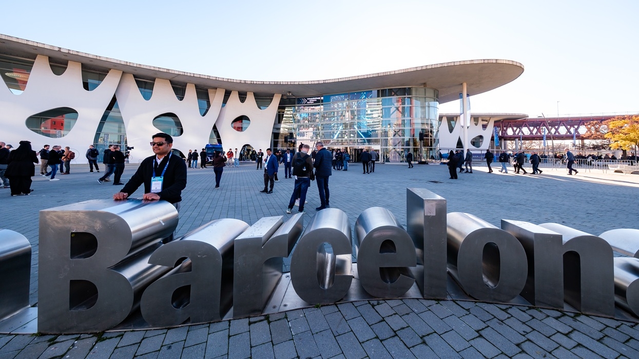 People at ISE 2026 outside modern Barcelona convention center, with large art installations.