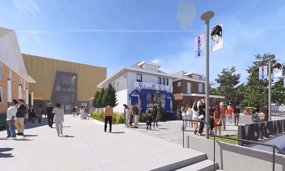 People at Motown Museum entrance with banners and modern building in the background.