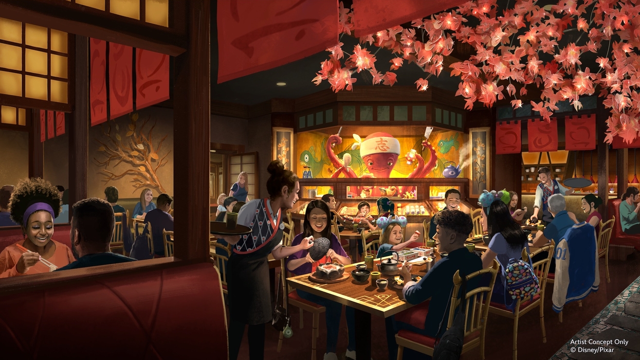 People dining in a vibrant, Asian-themed restaurant with cherry blossom decorations.
