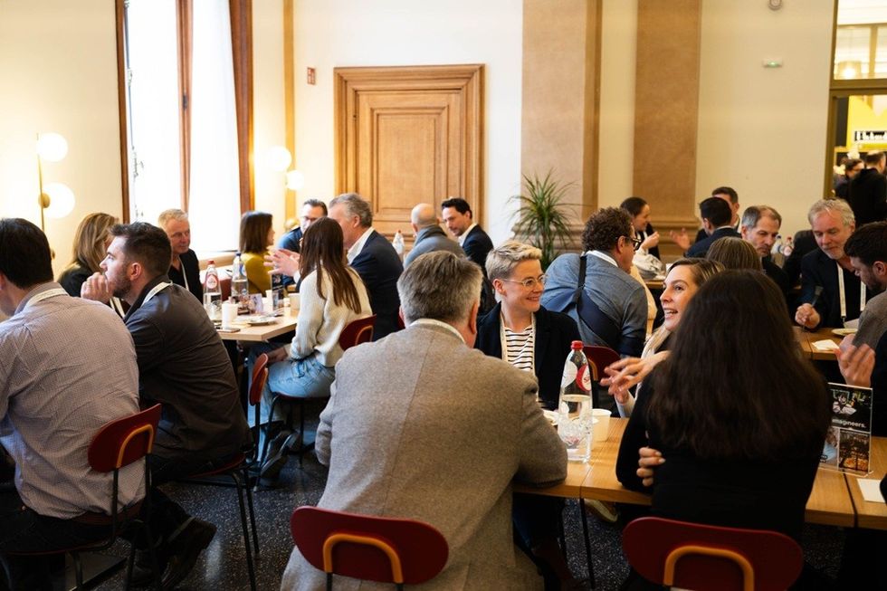 People engaged in conversation at the Brand Experience Center Conference 2025.