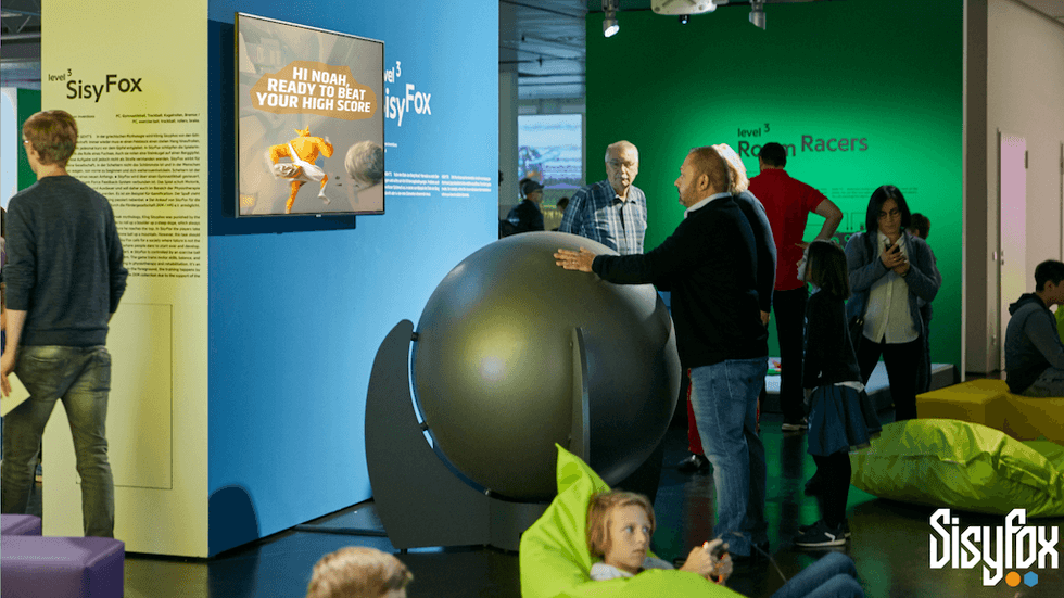People engaging with a giant ball game at an interactive gaming venue from SisyFox