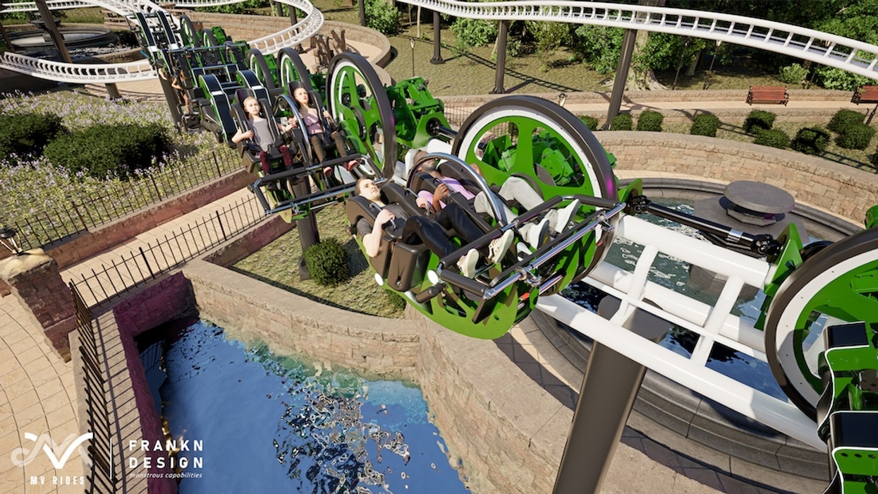 People enjoy a green, futuristic roller coaster (Martin & Vleminckx Unicoaster) with overhead tracks and scenic background.