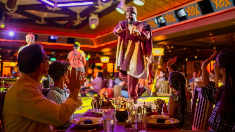 People enjoy a vibrant performance in a lively restaurant setting.