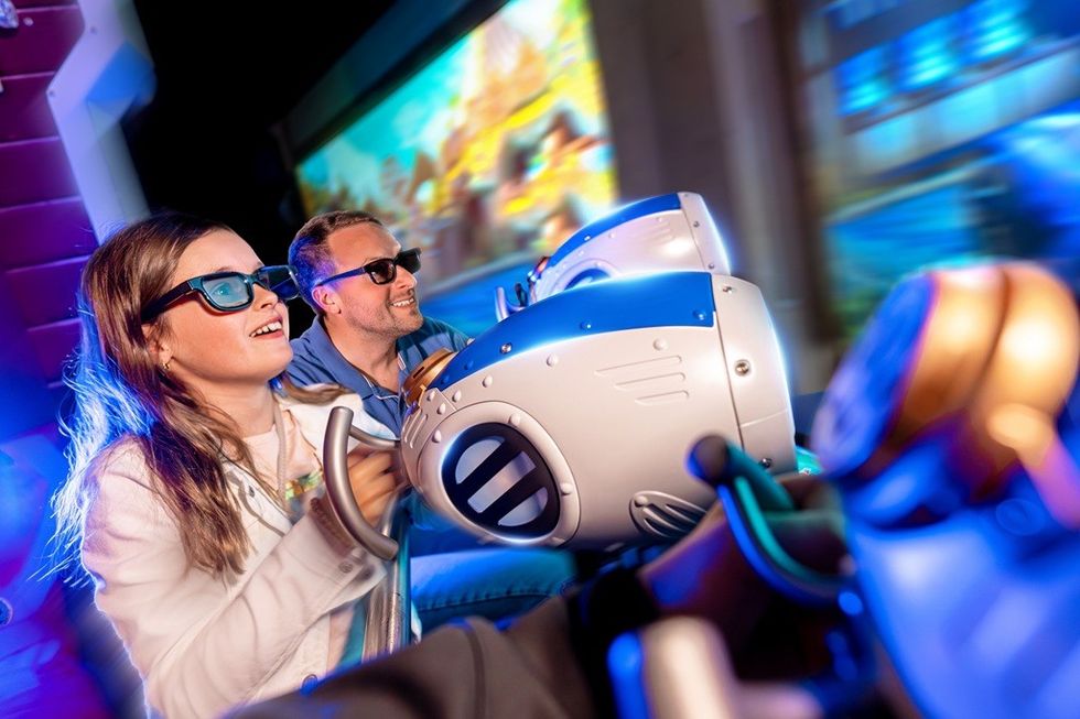 People enjoying a 3D theme park ride with immersive glasses.