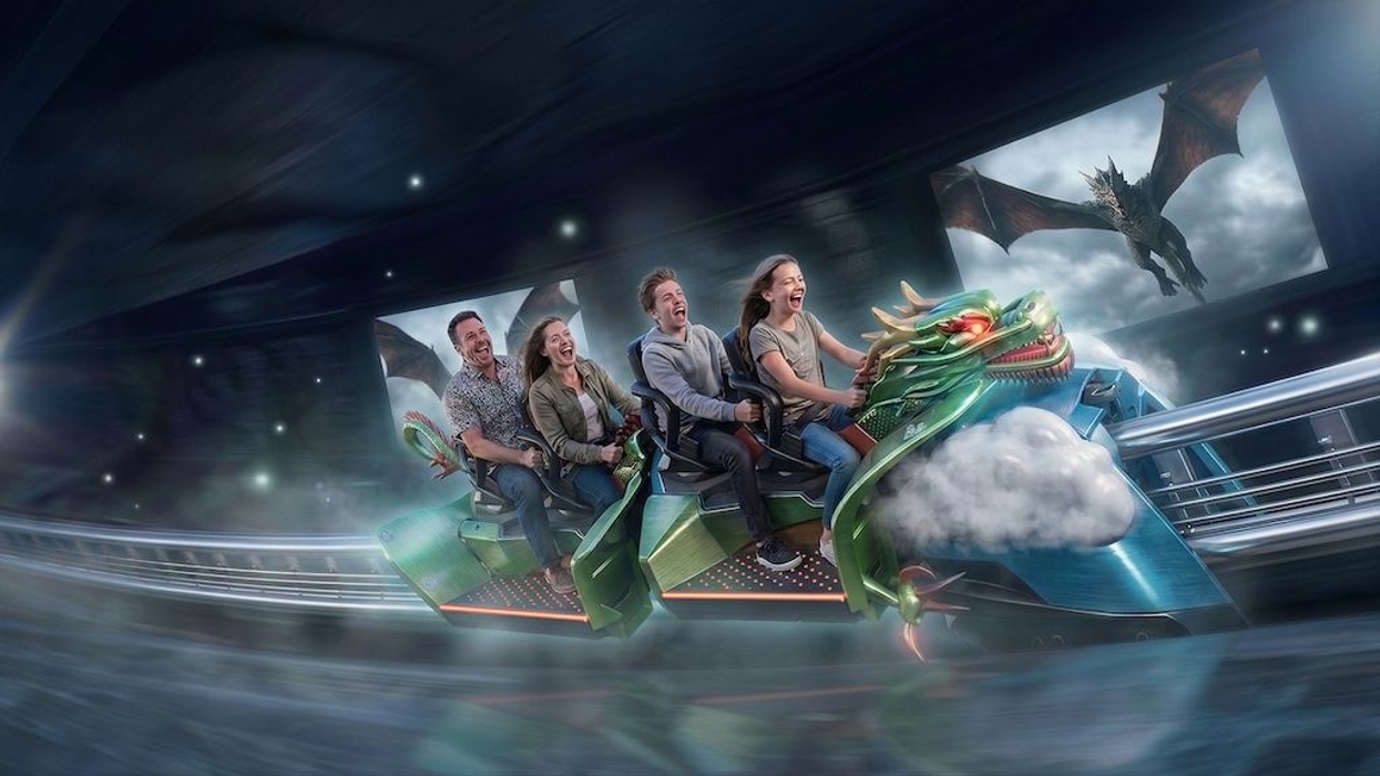 People enjoying a dragon-themed roller coaster ride with dragon visuals in the background - concept art for Maurer Spike Tandem
