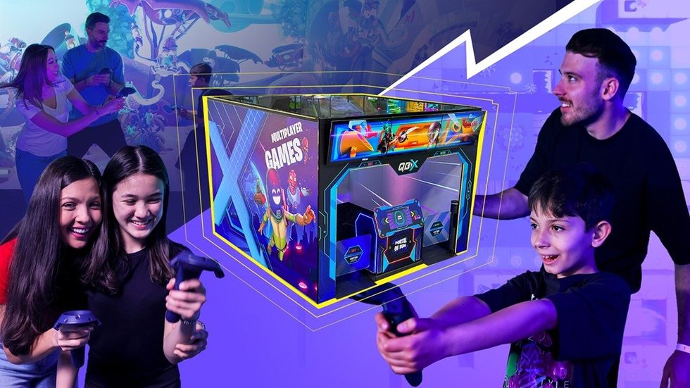 People enjoying a vibrant arcade multiplayer game, holding controllers enthusiastically.