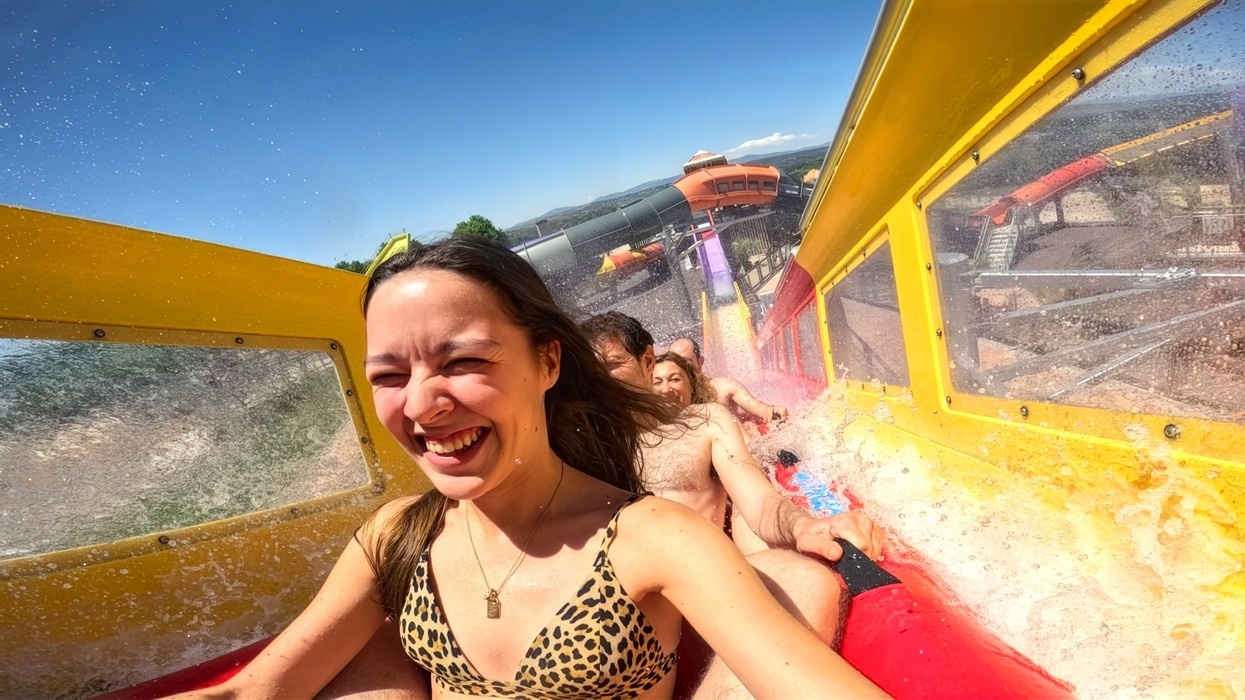 People enjoying a water slide ride named Kilauea on a sunny day at a water park, Aquópolis Villanueva de la Cañada