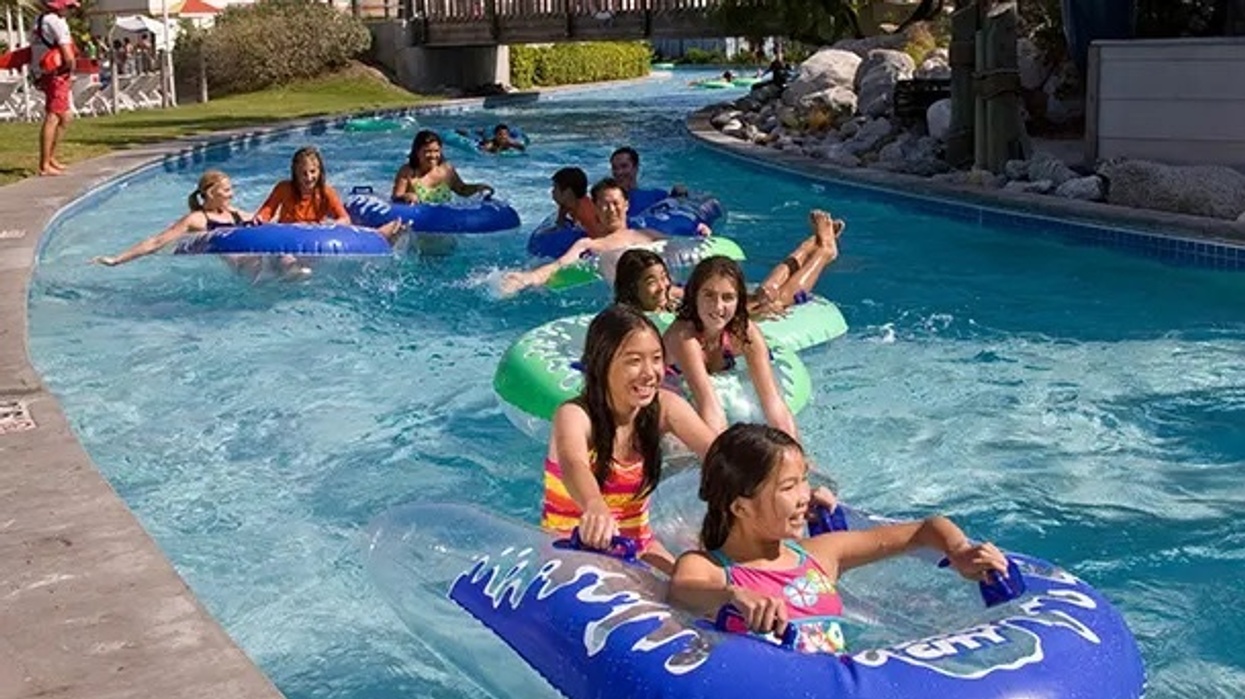 People having fun on inflatable tubes in a water park's lazy river.