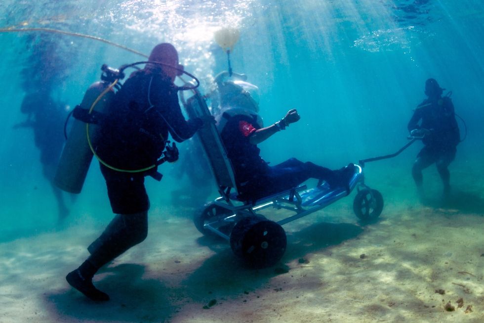 people in a wheelchair using seatrek helmet diving