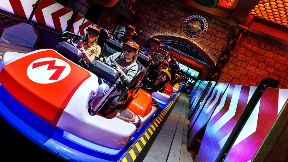 People in AR headsets on a Mario-themed theme park ride.