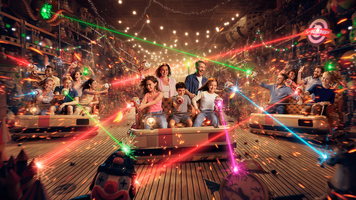 People in bumper cars at Grona Lund enjoying a vibrant laser tag game indoors.