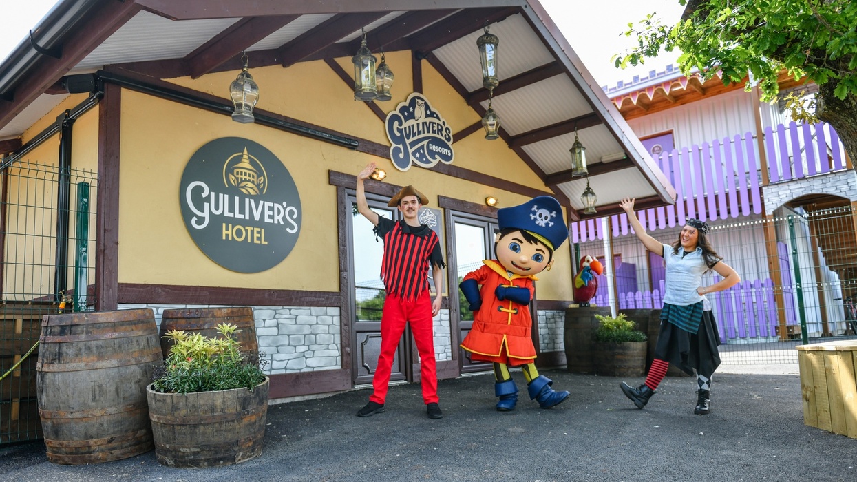 People in pirate costumes outside Gulliver's Hotel entrance, with a large character figure.