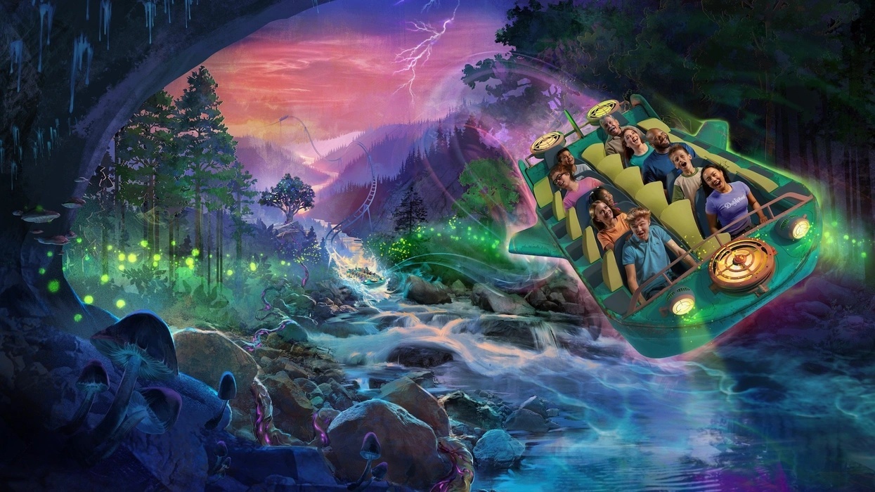 People on a futuristic ride called NightFlight Expedition through a colorful, magical forest with glowing elements.