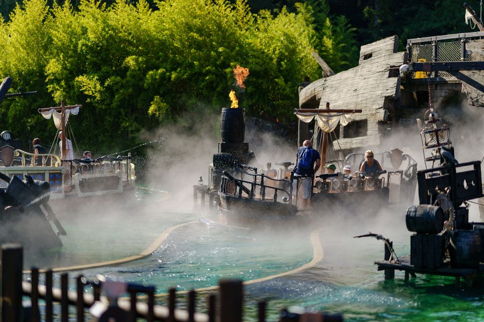 People on a theme park pirate ride with fog and fire effects at \u200bFraispertuis City
