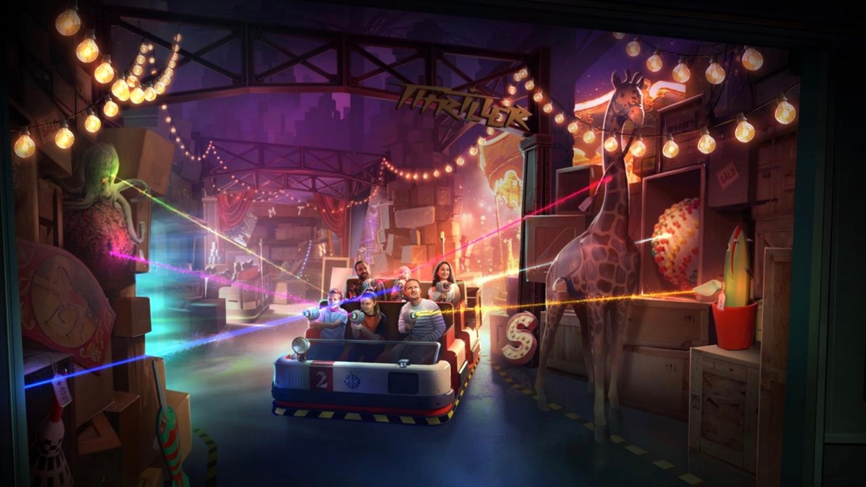 People on a theme park ride with laser guns, surrounded by colorful, whimsical decor.