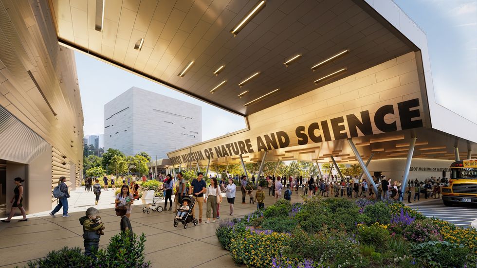 People outside the Perot Museum with "Nature and Science" sign, surrounded by plants and flowers