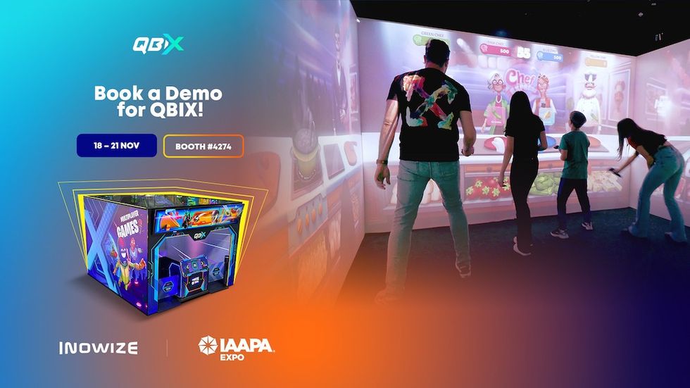 People playing an interactive wall game at the QBIX demo booth.