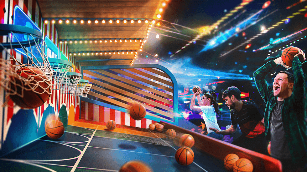 People playing arcade basketball under colorful lights.
