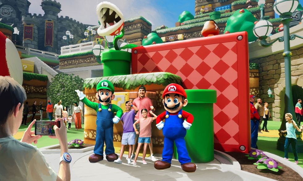 People posing with Mario and Luigi at a themed park attraction called Epic Universe