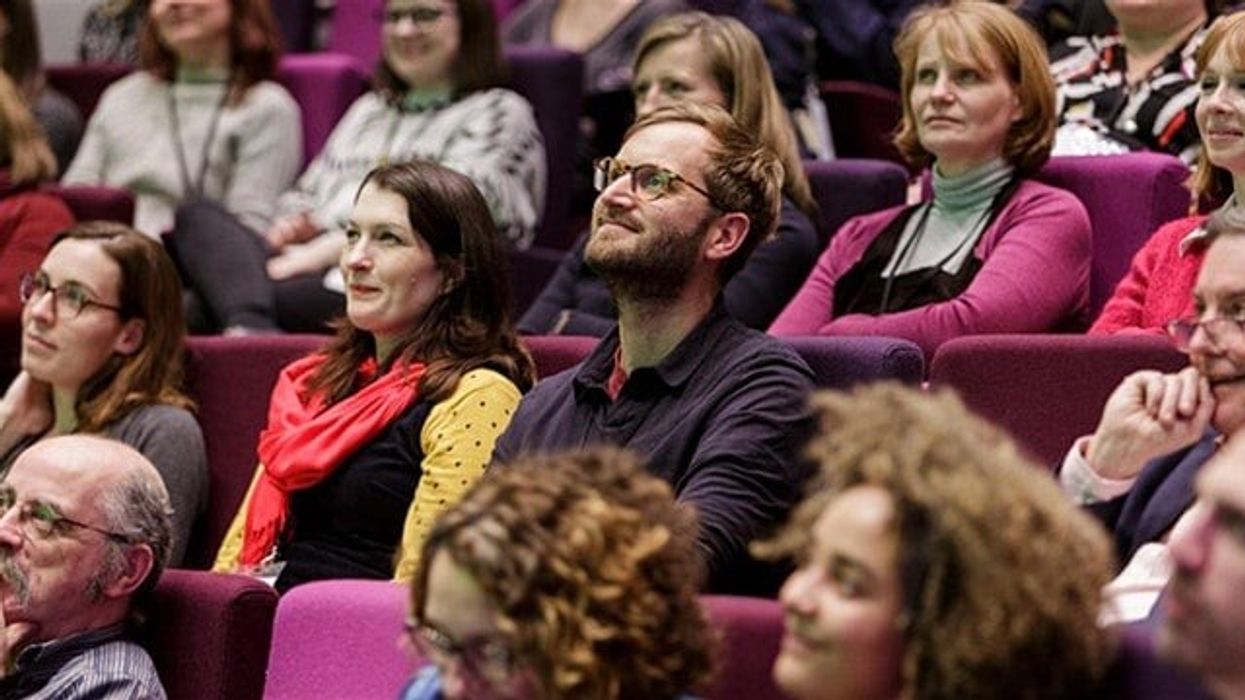 People sitting in a conference theatre at let's get real conference