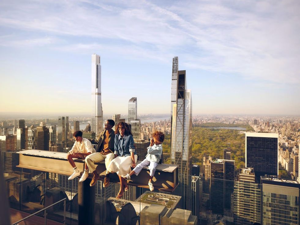 People sitting on a skyscraper, overlooking a city skyline and Central Park.