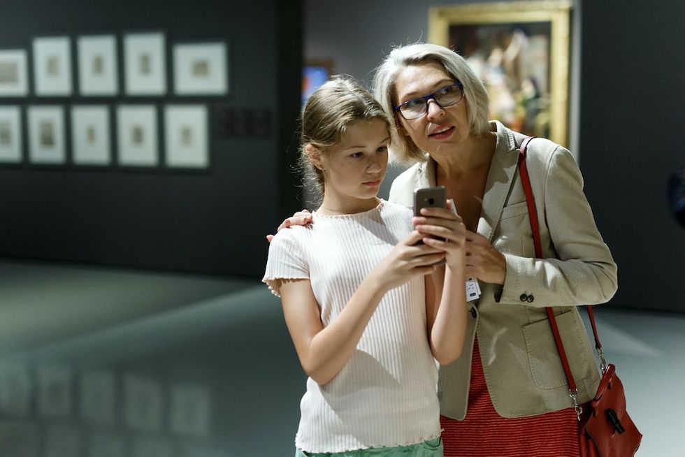 People using phone in museum