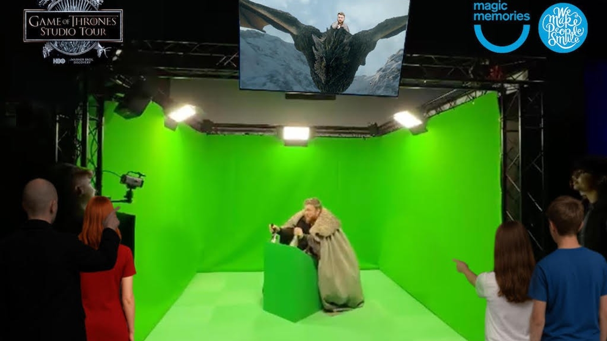 People viewing a Game of Thrones green screen studio tour setup.