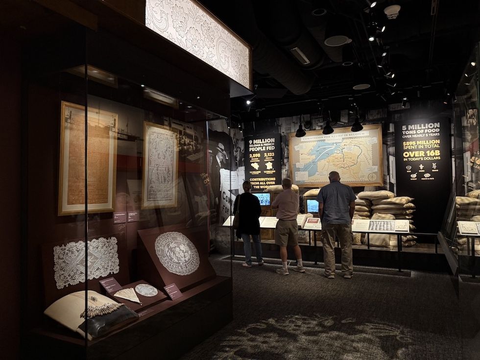 People viewing exhibits at Herbert Hoover Presidential Library and Museum with artifacts and informational displays