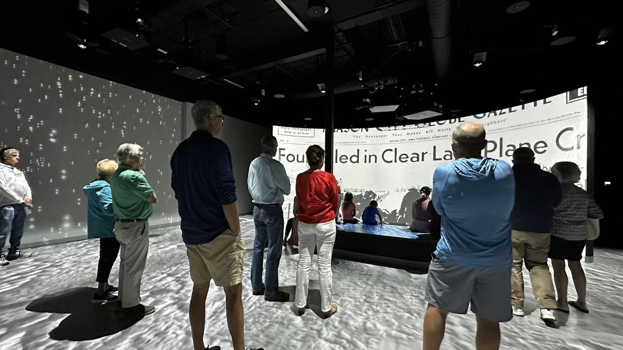 people viewing multimedia projections at Not Fade Away at the Surf Ballroom Experience Center