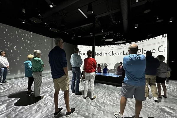 people viewing multimedia projections at Not Fade Away at the Surf Ballroom Experience Center