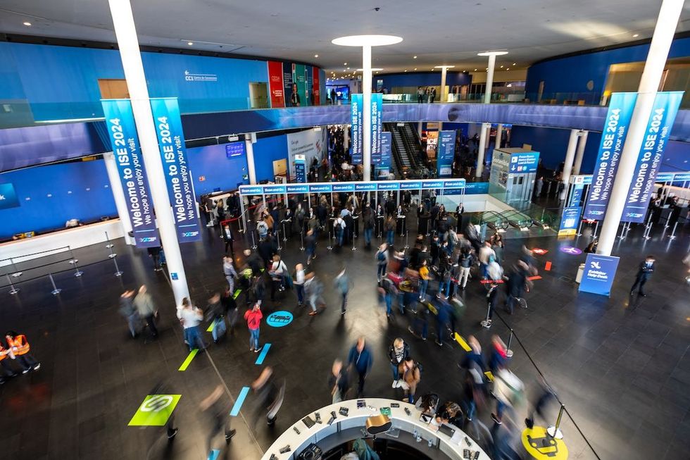 People walk into the 2024 ISE trade show
