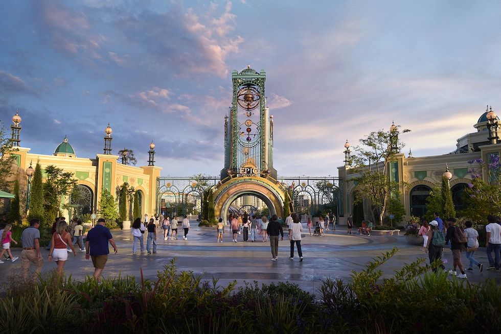 People walking toward a grand, ornate theme park entrance at sunset - Celestial Park, Epic Universe