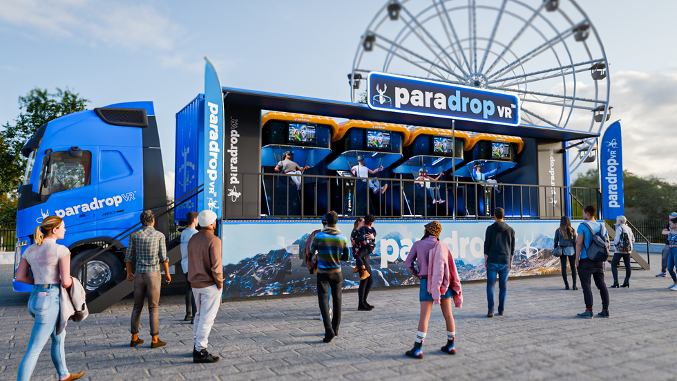 People watching a ParadropVR truck, with individuals in VR stations and a Ferris wheel behind.