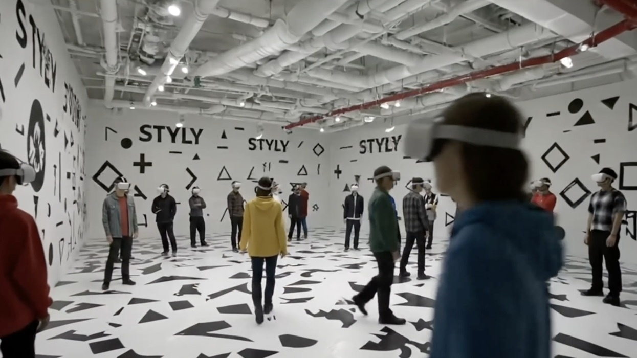 People wearing VR headsets in a geometric-patterned room labeled "STYLY."