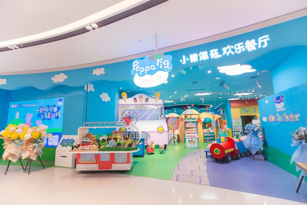 Peppa Pig-themed play cafe with colorful decor and toys.