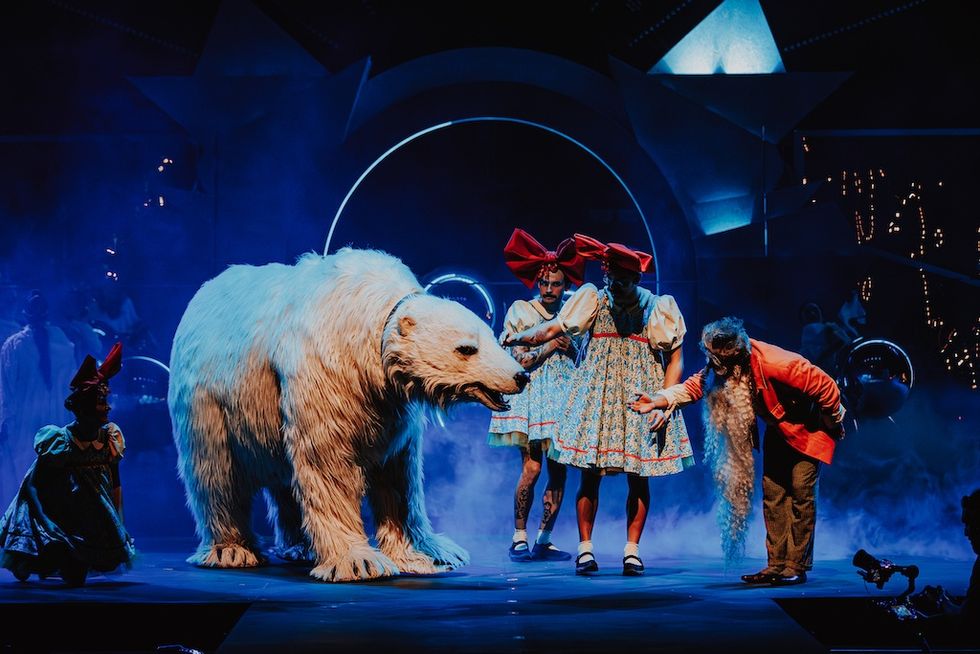 Performers on stage with a large polar bear puppet and colorful costumes, Cirque de Soliel's ILLU in Andorra