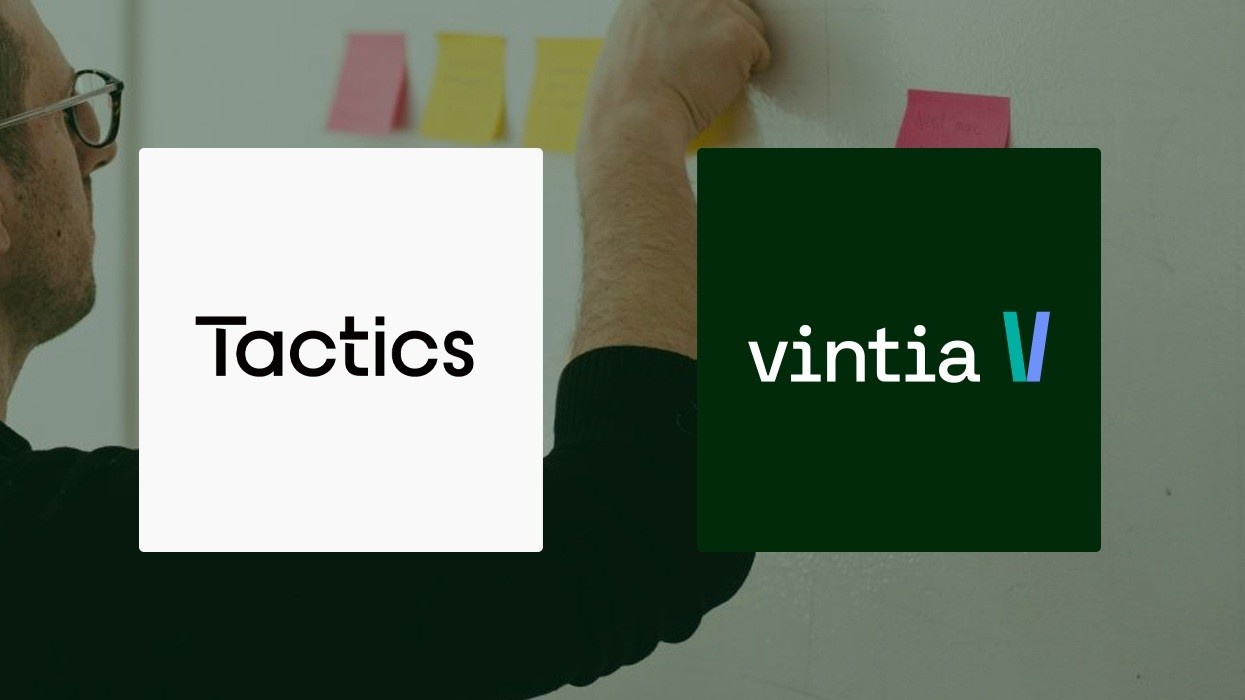 Person arranging sticky notes on a wall; overlaid Tactics and Vintia logos.