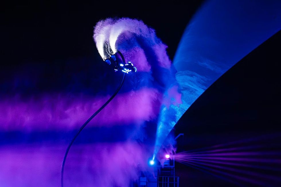 Person doing a flip with a water hovercraft at Symphony of the Green Island, C\u00e1t B\u00e0 Island