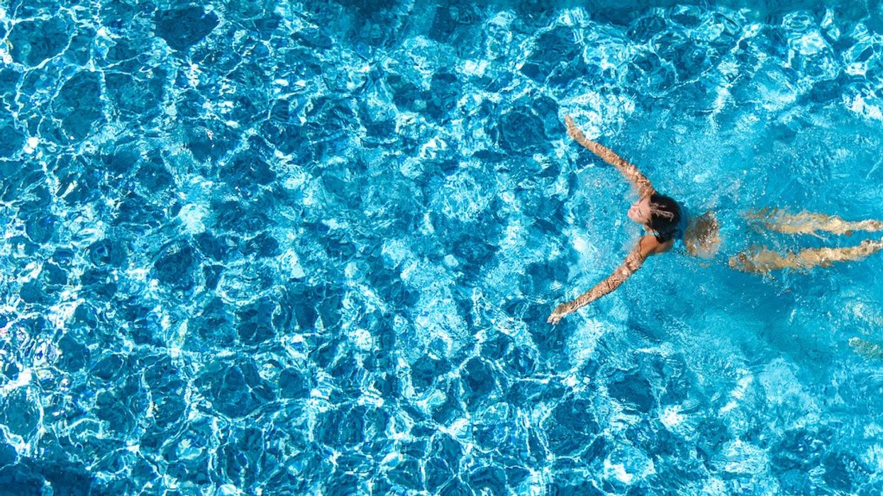 Person in swimming pool aerial view