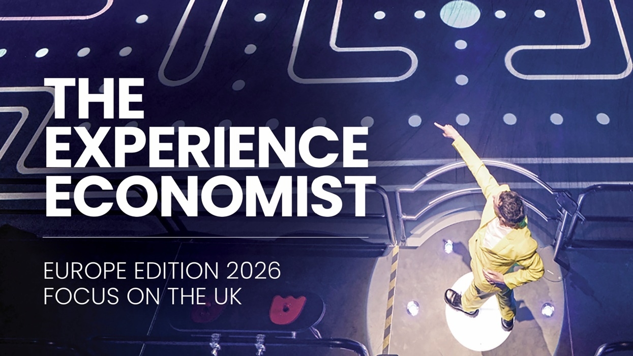 Person in yellow suit pointing on stage, text: "The Experience Economist, Europe 2026".