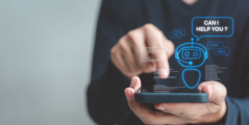 Person interacting with AI chatbot on smartphone; chatbot asks, "Can I help you?"