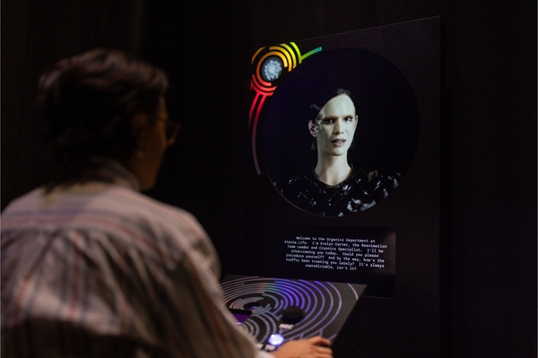 Person interacts with a futuristic AI hologram displaying text on a dark screen.