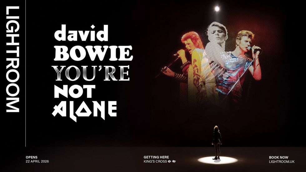 Person looking at projected, colorful images of a performer on stage.