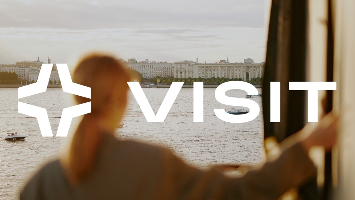 Person looking out at river with large "VISIT" text and symbol overlaid.