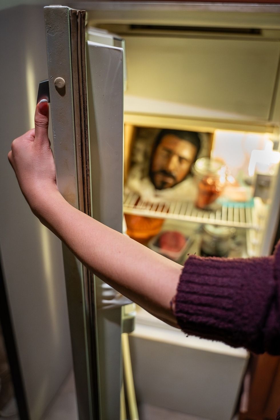 Person opening refrigerator door in The Mind of a Serial Killer: The Experience.