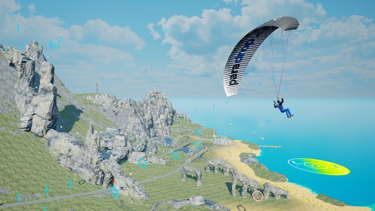 Person paragliding over rocky cliffs in ParadopVR by a blue ocean under a bright sky.