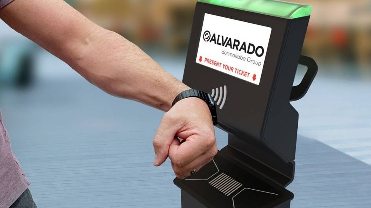 Person scanning their wrist band at an Alvarado UltraQ Pedestal